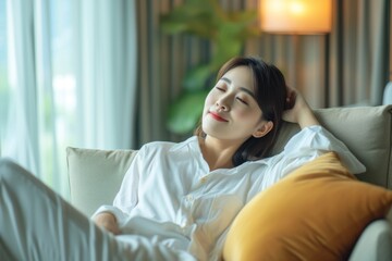 Work-life balance relaxation with Asian working business woman healthy lifestyle take it easy resting in comfort city hotel or home living room having good time with peace of mind, self-satisfaction
