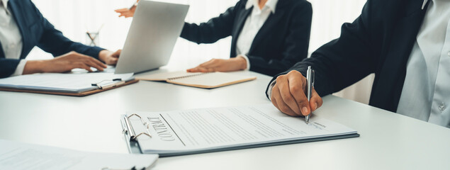 Two business executive in boardroom discuss term and company merging agreement, review corporate...