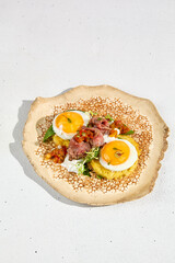 A beautifully arranged plate of potato pancakes with roast beef and a sunny side up egg, ready for breakfast