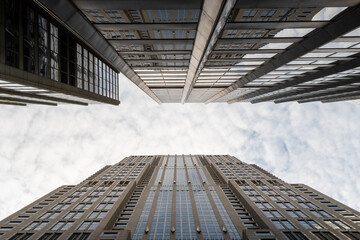 Two skyscrapers almost touching each other above the sky