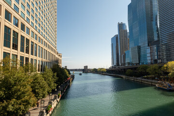 Riverwalk passes between the tall buildings in the city. Towers and water.