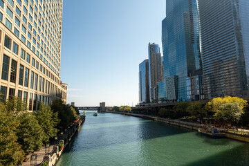Riverwalk passes between the tall buildings in the city. Towers and water.