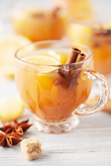 Homemade Wassail Mulled Apple Cider with Lemon and Spices in glasses. Winter alcoholic hot drink.