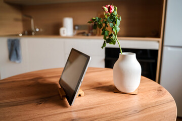 Beautiful modern kitchen interior with wooden set and tablet on the table