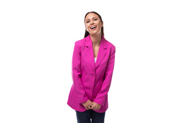 young office worker woman with black hair dressed in a pink jacket looks happy