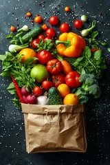 Fotobehang A kraft bag with vegetables and fruits on a black background. Food delivery © Александр Лобач