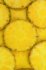 Pineapple juicy yellow slices as a background.