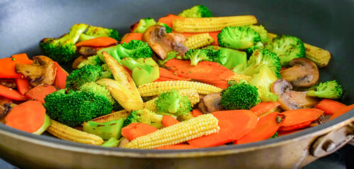 Stir fry vegetables on plate. Vegetarian food, bell pepper, broccoli, mushrooms, corn. Homemade fresh fried vegetables for restaurant, menu, advert or package, close up, selective focus