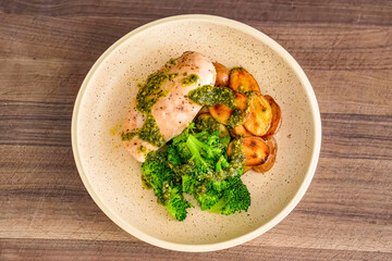 Healthy fresh meal, bowl with vegetables, chicken. Homemade delicious lunch with chicken, potatoes, broccoli for restaurant, menu, advert or package, close up selective focus. Top view.