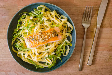 Pasta with roasted salmon fillet and herbs in bowl. Delicious homemade pasta salmon dish, serving food for restaurant, menu, advert or package, close up. Top view. - 723254872