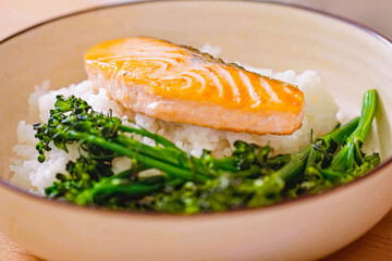 Roasted salmon fillet with rice in bowl. Homemade cooking fresh sliced salmon with greens, serving food for restaurant, menu, advert or package, close up, selective focus - 723255009
