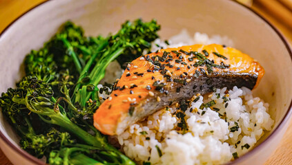 Roasted salmon fillet with rice in bowl. Homemade cooking fresh sliced salmon with greens, serving food for restaurant, menu, advert or package, close up, selective focus - 723255048