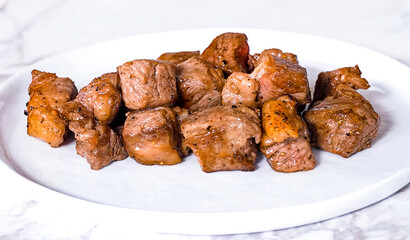 Beef grilled meat shish kebab on white plate. Homemade roasted sliced beef, serving food for restaurant, menu, advert or package, close up, selective focus - 723255246