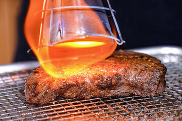Beef steak grilled fillet meat with flame. Homemade cooking beef steak, serving food for restaurant, menu, advert or package, close up, selective focus - 723255254