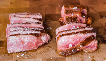 Beef steak grilled sliced meat on wooden board. Homemade roasted beef steak, serving food for restaurant, menu, advert or package, close up, selective focus - 723255276