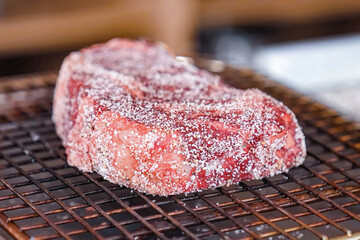 Beef steak raw fillet meat preparing for grilling. Homemade cooking beef steak, serving food for restaurant, menu, advert or package, close up, selective focus - 723255433