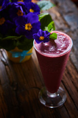 Delicious berry smoothie on table