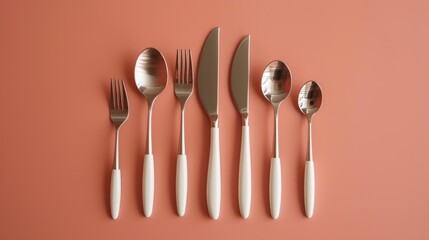  a set of five forks, spoons, and knives on a pink background with a white stripe on the end of the fork and a white stripe on the end of the end of the fork.