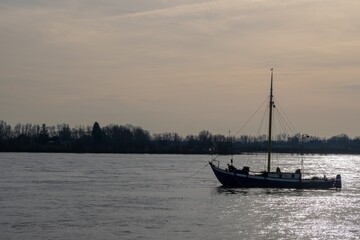 fishing boat on a large river in the evening sun