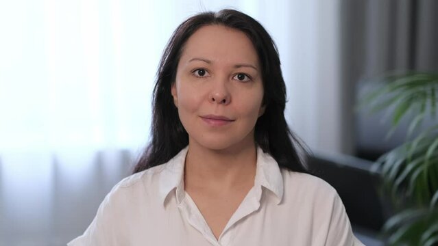 Confident professional woman in a white blouse, poised and ready for business challenges. Ideal for corporate profiles and leadership articles.