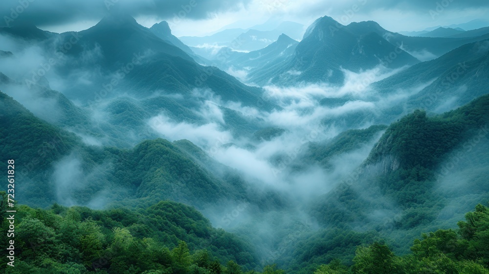 Poster a view of a mountain range covered in fog and low lying clouds in the foreground, with trees in the 