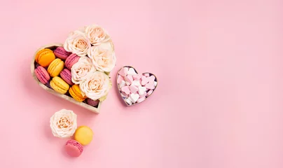 Rolgordijnen Cookies Macaroons in Gift Box, Rose Flowers and Candies on Pink Background. Holiday Presents Concept © Iuliia Metkalova
