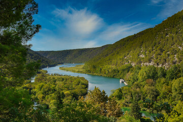 Fototapeta na wymiar Krka Majesty: A Breathtaking Aerial Vista of the River, Trees, Hills, and Blue Sky