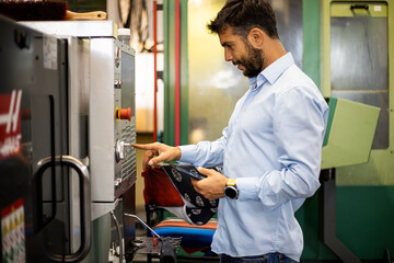 The engineer supervises the production of electrical devices in the factory.