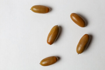 Five acorns on a white background © Dmitriy Kravchenko