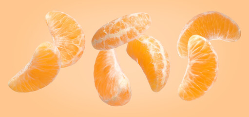 Pieces of fresh ripe tangerine falling on pale orange background, banner design