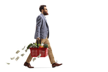Bull length profile shot of a man walking with a shopping basket and losing money