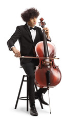 Young male artist sitting on a chair and playing a cello