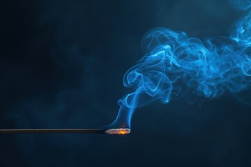 Chinese incense stick emits swirling blue smoke on black backdrop