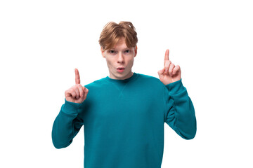 a young red-haired man with a blue sweater announces the news. advertising concept