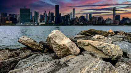 The New York skyline as seen from the rock cliff pier and overlook of Long Island is a large island...