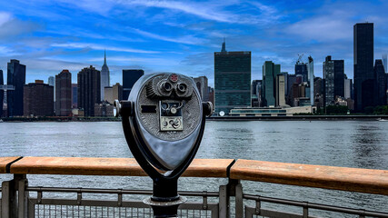 Binoculars on the pier viewer and observer Long Island is an island that extends across New York...