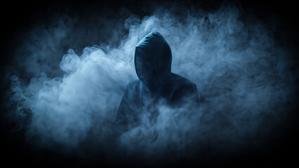 Human in a hood against the background of smoke