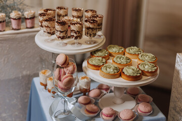 Candy bar at a wedding. Delicious desserts. Beautiful decorations. Fruits. Sweet cakes on your holiday. Birthday. Sweet life.