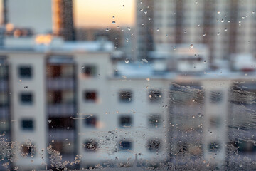 View of multi-storey residential buildings through a frosty window - 723297478