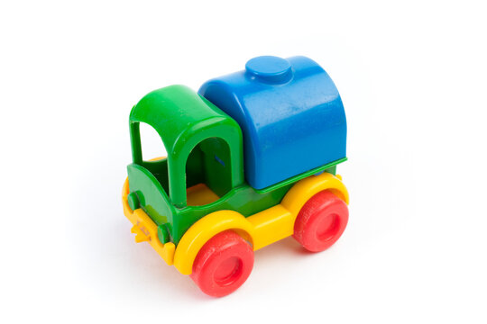 Children's toy multi-colored plastic truck on a white background. For the development of the child.