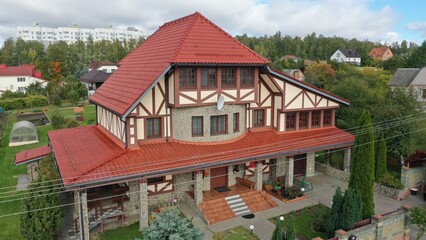 Huge expensive house, cottage in Europe in the colonial modern style of architecture with red tile...