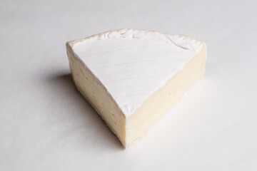 piece of cheese, cheese on a board, cheese on white background