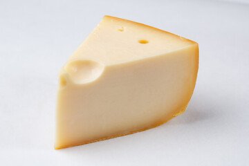 piece of cheese, cheese on a board, cheese on white background