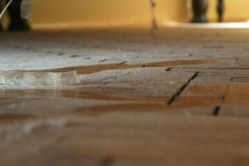 Dust on the wooden floor under the bed