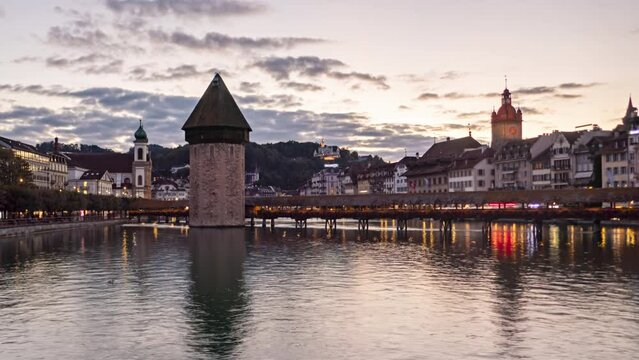 Day to night hyper lapse panorama Lucerne old town and and Chapel bridge, Switzerland.