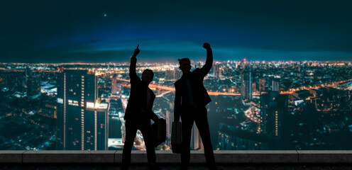 Two joyful businessmen celebrate with a night cityscape backdrop, symbolizing business success and...
