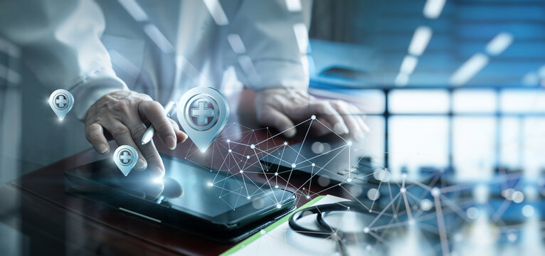 A doctor using a tablet computer to search for a location.