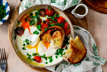 Turkish eggs. cilbir.traditional breakfast dish. selective focus. hugge style