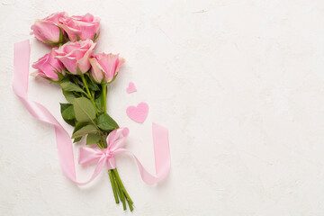 Pink roses with hearts on concrete background, top view. Valentines day concept