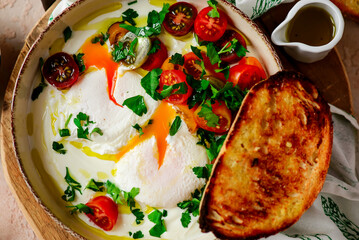 Turkish eggs. cilbir.traditional breakfast dish. selective focus. hugge style